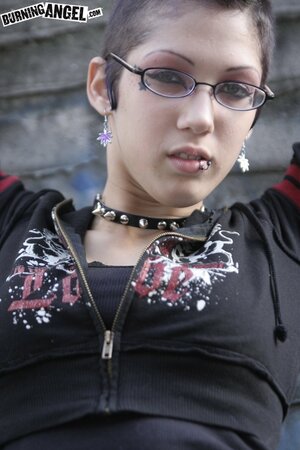 Sexy goth girl with glasses and mohawk shamelessly exposes her pussy outdoors
