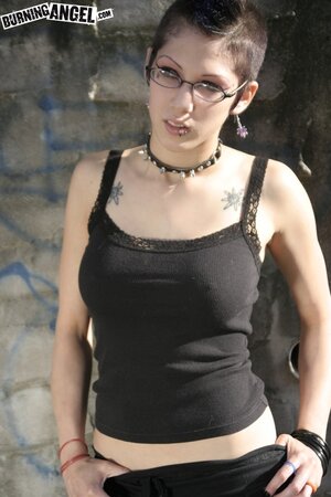 Sexy goth girl with glasses and mohawk shamelessly exposes her pussy outdoors