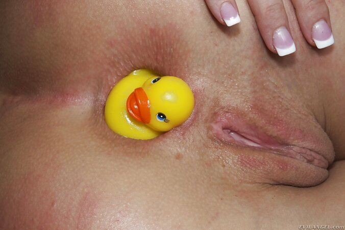Comely minx naked and eager to play with rubber duck and new white dildo