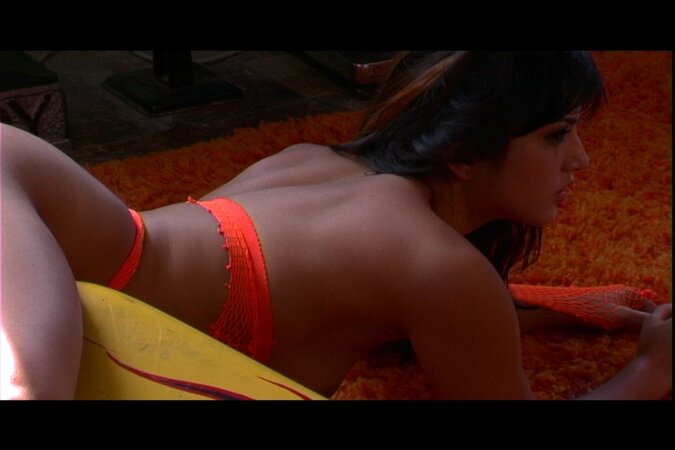 MILF from India Sunny Leone in orange lingerie poses on a yellow lounger