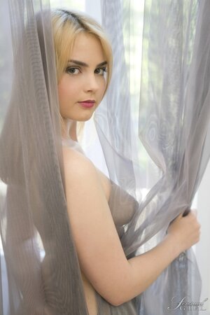 Modest blonde takes off black lingerie and wraps herself in a curtain
