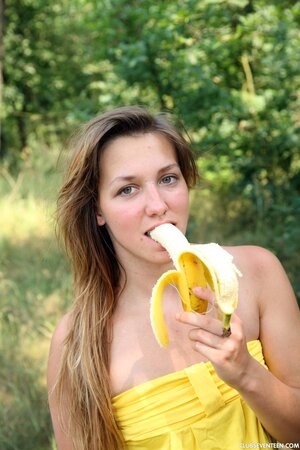 Hungry girl eats a banana in the forest and masturbates vagina by tree