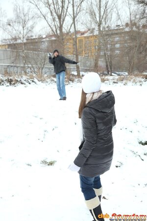 Spicy girl plays in the snow with young man and hurries home to play adult games