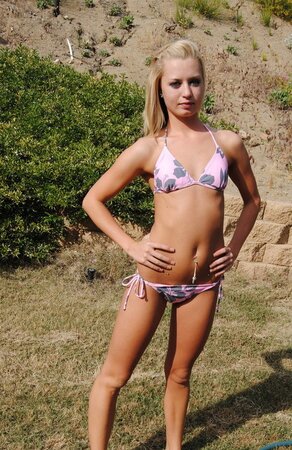 Sweet blonde slowly pulls sexy bikini down to demonstrate her slim body