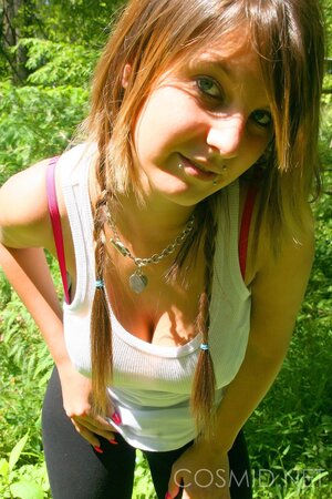 Slim hussy with sexy piercing shows her enormous tits on a sunny day outdoors