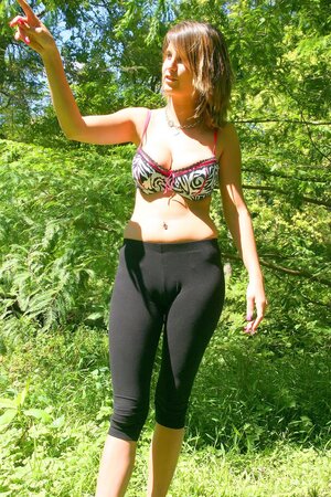Slim hussy with sexy piercing shows her enormous tits on a sunny day outdoors