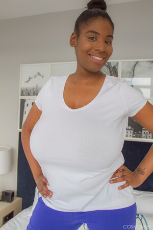 Ebony hottie reveals her impossibly-huge natural breasts for the camera