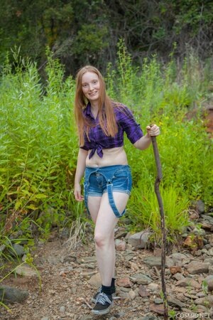 Red-haired country girl strips to flaunt her big breasts in the woods