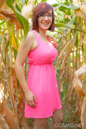 Slutty MILF with glasses takes off clothes to pose naked in the cornfield