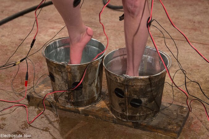 Naked slut with feet inside two buckets dominated by hotties who use electricity