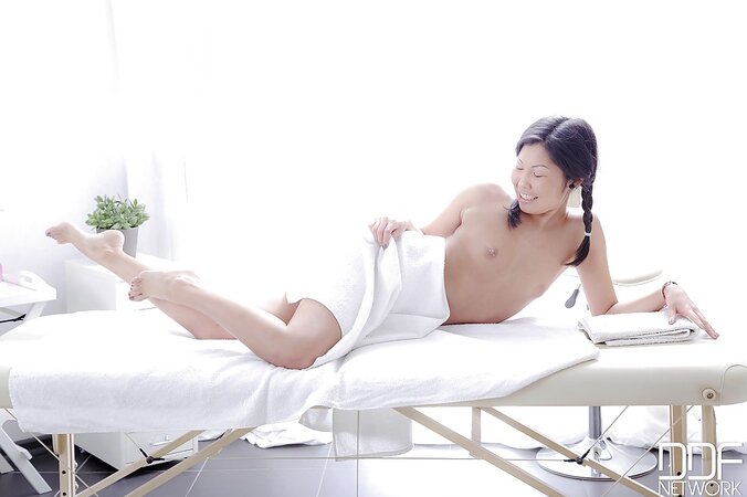 Sexy Asian hussy undresses slowly and flaunts her body on the massage table