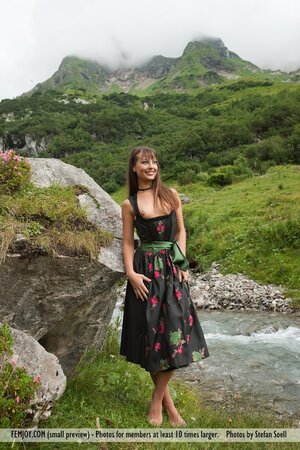 Cute hussy in traditional dress lifts skirt up to tease with wet pussy outdoors