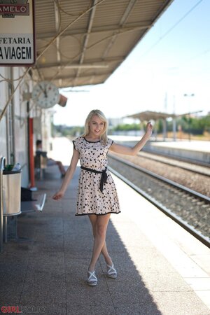 Charming blonde sweetie in dress flashes panties on the railway station