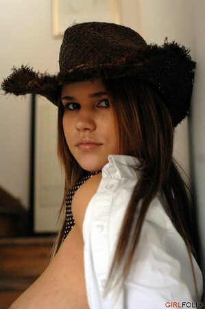 Chubby girl displays big natural boobs in leather boots and straw hat