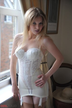 Gorgeous blonde discards vintage dress till she is left in corset and stockings