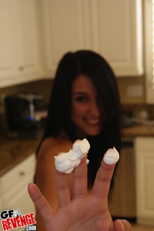 Naked brunette girlfriend comes to the kitchen to play with whipped cream