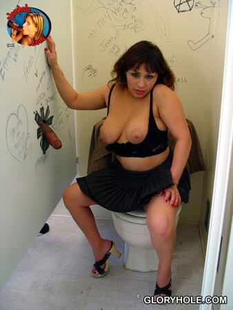 Modest-looking woman gives slobbery blowjob in a bathroom with gloryhole