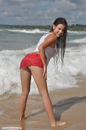 Angelic teen hussy shows off her awesome body stripping on the sandy beach