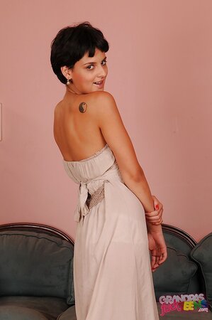 Enticing short-haired wench doffs long dress and teases with her slender curves