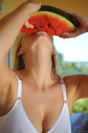 Dirty-minded blonde plays with her pussy while eating watermelon outdoors