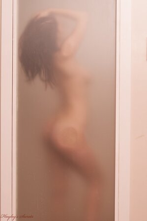 Lovable busty wench gets naked and poses for the camera in the shower