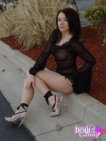 Sassy brunette shows nice tits while seductively posing in transparent dress