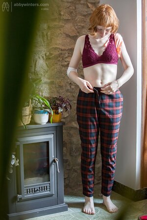 Redheaded cutie puts on her pants and looks very, very good