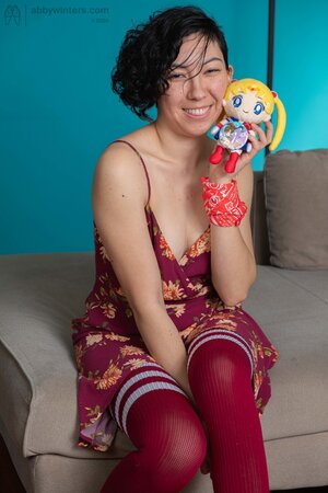 Brunette playing with her pussy and her Sailor Moon toy
