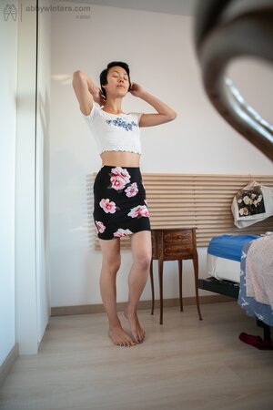 Short hair babe is showing her small boobs and long legs