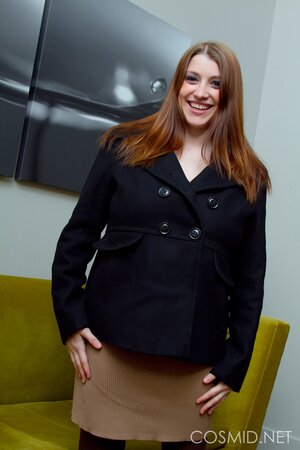 Chubby girl with a charming smile is showing off in her pantyhose