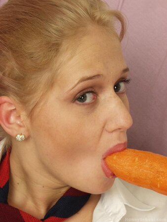 Schoolgirl removes her outfit and plays with a large carrot