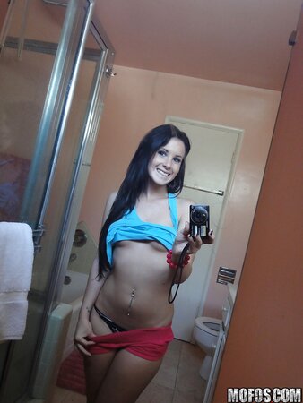 Saucy stunner taking some selfies in the bathroom while stripping