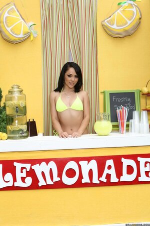 Sexy girl is fascinating exposing alluring body and selling lemonade