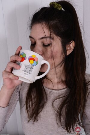 Hot Asian slut sips on her tea while flaunting her tight beaver
