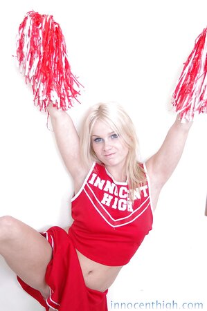 Cheerleader in the red Innocent High uniform gives upskirt view and bares tits