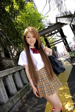 Oriental MILF Ria Sakurai squats wearing a very short skirt and flashing panties