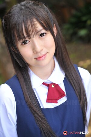 Innocent Japanese schoolgirl with beautiful eyes walks seductively under sun