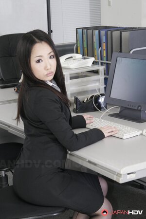 Pretty Asian office chick in black stockings is ready to show off hairy cunt