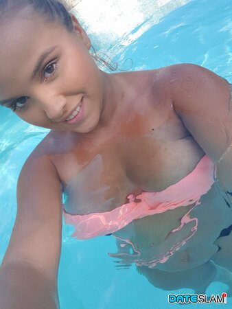 Olivia hides her huge tits while taking cute poolside selfies