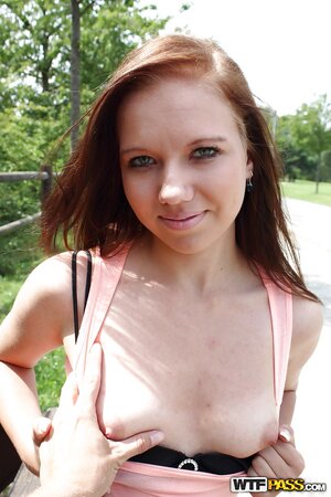 Amateur redhead chick agrees to show her tits on camera in the public place