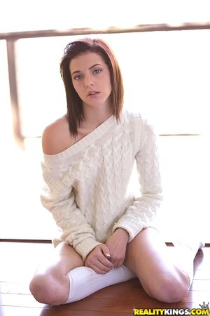 Thoughtful teen Kiera Winters takes off white sweaters and panties on the balcony