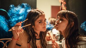 Sexy brunettes girls are scissoring on the theatre floor