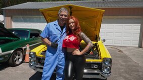 DILF with ae big cock is fucking a redhead next to the cars