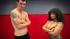 The wrestling match features a busty ebony and a hung man