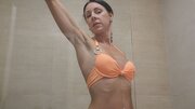 Skinny brunette MILF fucks a floor mounted dildo in the shower