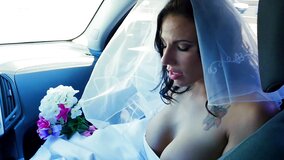 A woman gets penetrated in her wedding gown on the bed