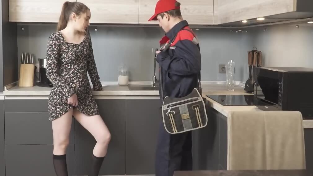 Naughty girl tempts plumber into spontaneous sex in the kitchen image