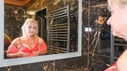Tarty blonde granny plays solo with a sex toy in the bathroom